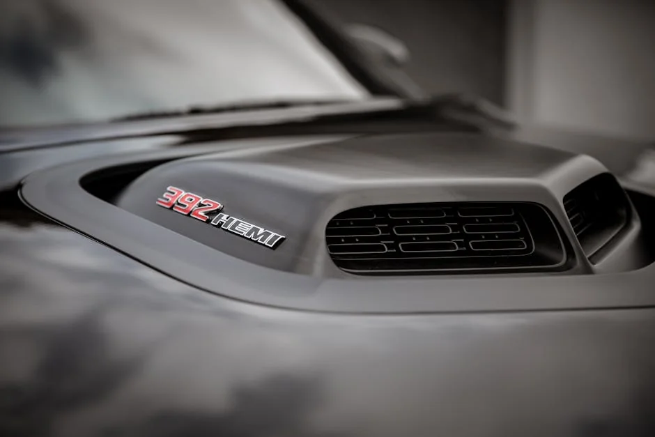 Detailed view of a car hood featuring a 392 HEMI badge and air intake. - benefits of cold air intake systems