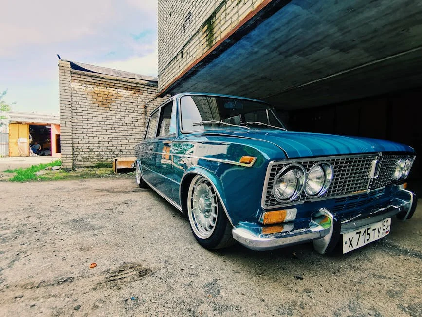 A classic VAZ-2103 in blue parked under a concrete structure, showcasing vintage charm. - best affordable project cars for beginners