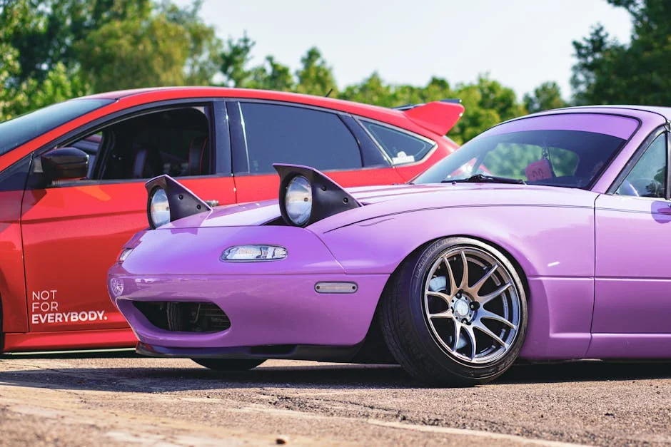 A vivid capture showcasing a customized purple and red car duo on a sunny day, perfect for auto enthusiasts. - best first cars for car enthusiasts