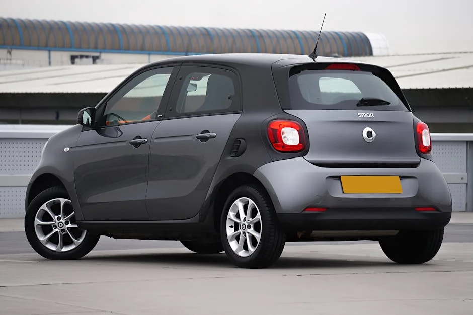 Gray Smart Forfour viewed from behind in a modern urban environment. - best fuel efficient cars for long commutes