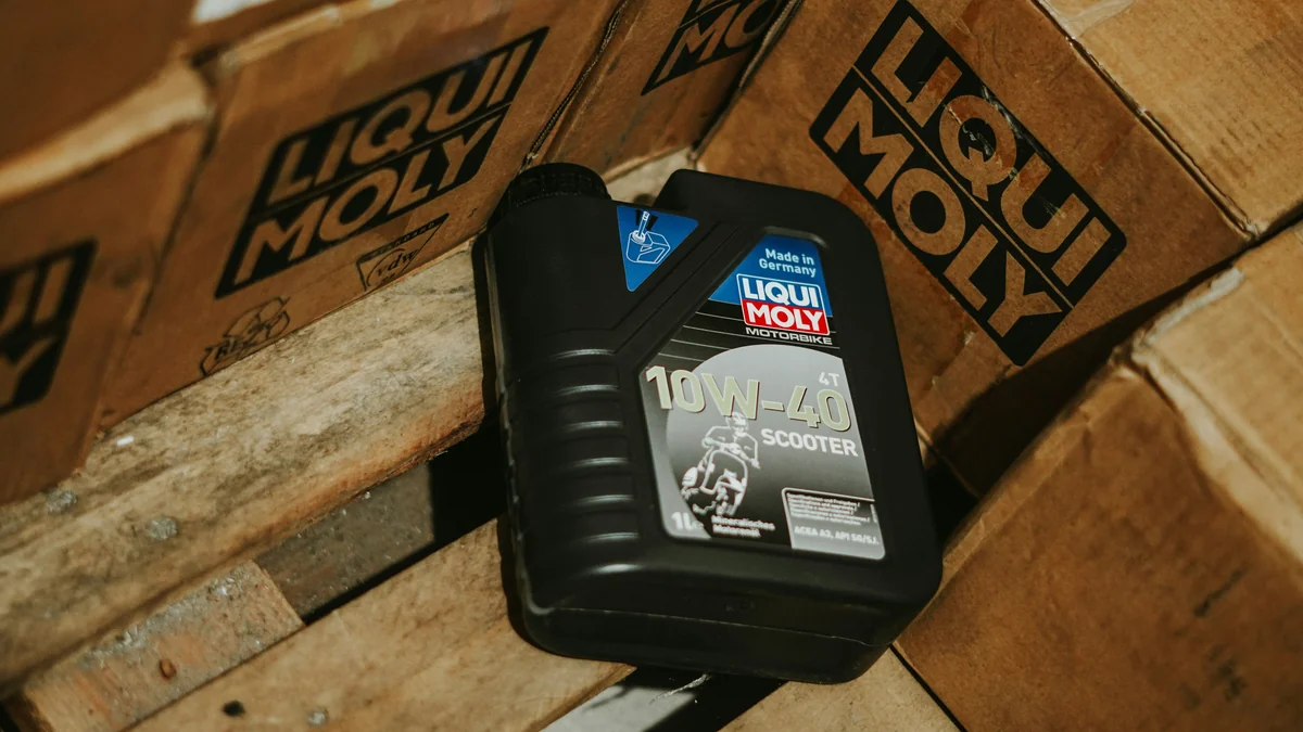 Oil bottle rests among stacked boxes. - best synthetic oil for high mileage engines