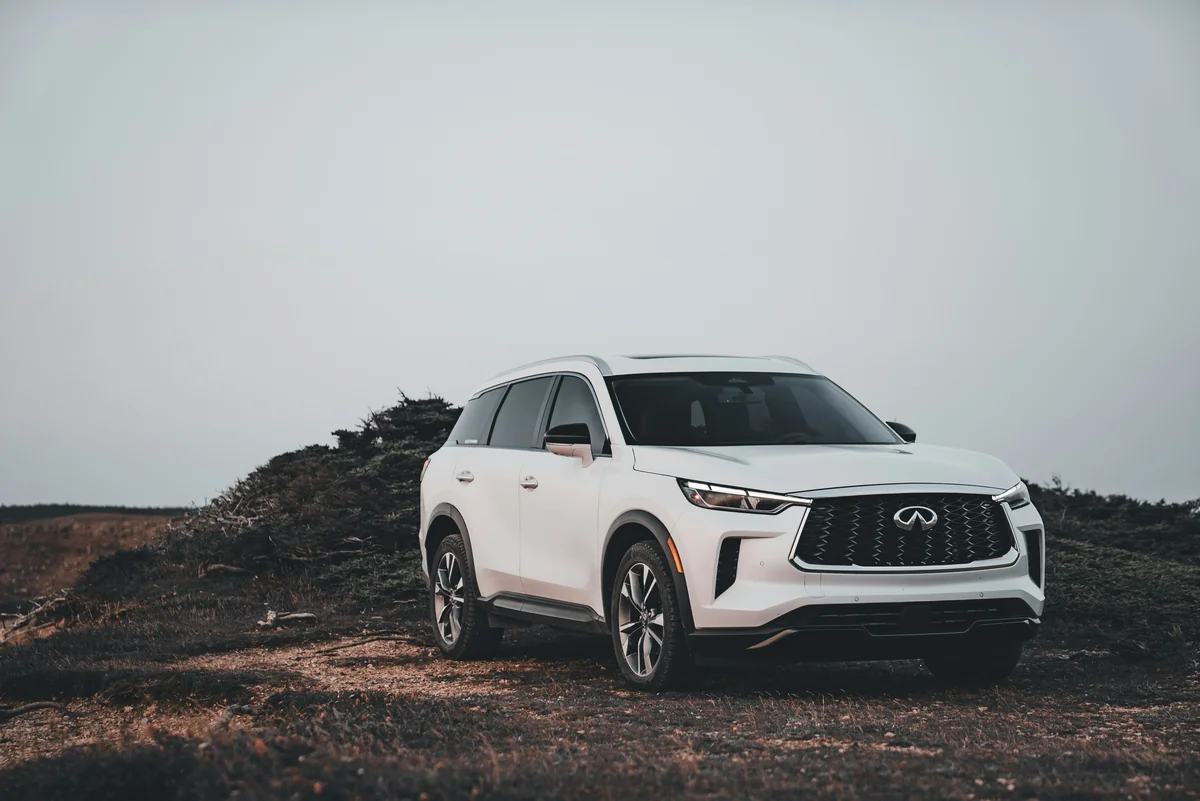 A white suv parked on a dirt road - most reliable used luxury suvs