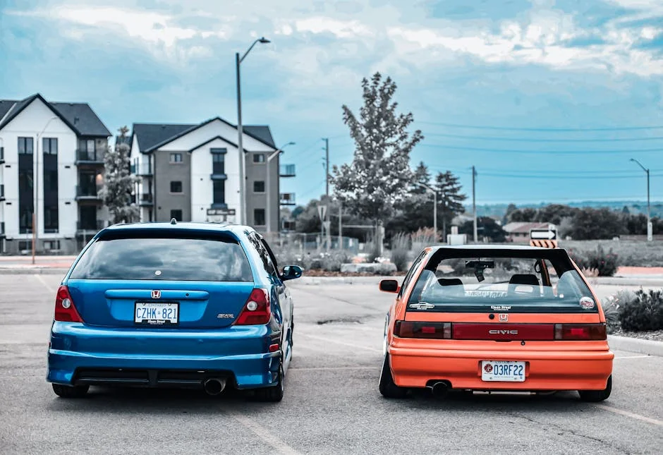 Two custom Honda Civic cars showcased in an urban parking lot, highlighting tuning culture. - stage 1 vs stage 2 tune differences