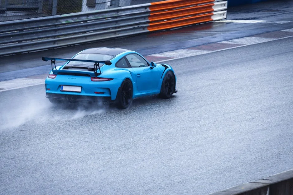 A sports car speeds on a wet racetrack, showcasing adrenaline and precision driving. - street legal track day cars