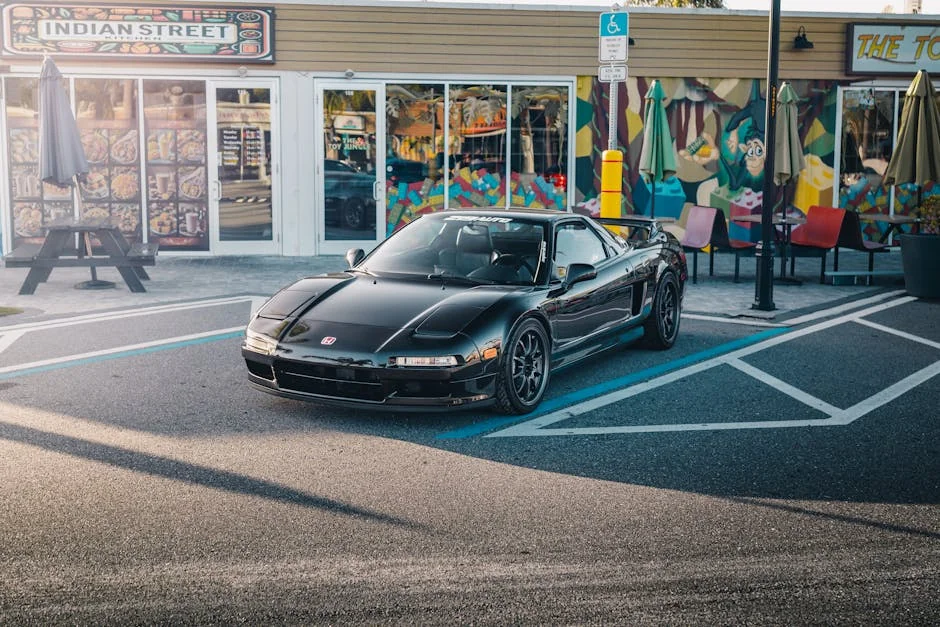A sleek black Honda NSX parked in front of colorful street art in Tampa, Florida. - underrated jdm cars under 10k