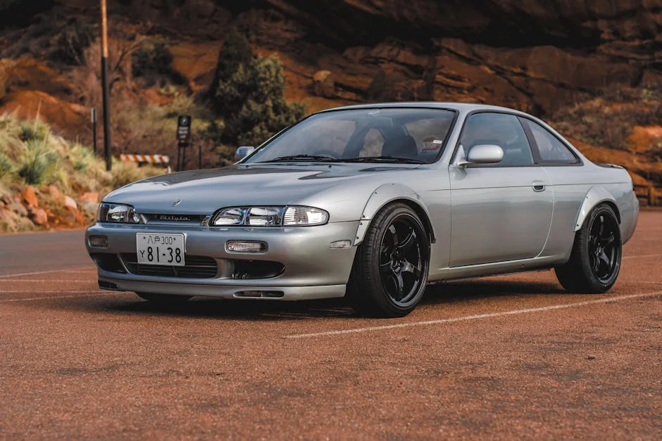 Gray Nissan Silvia car parked on a scenic road with a rocky backdrop under daylight. - underrated jdm cars under 10k